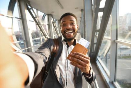 African worker at airport with passport